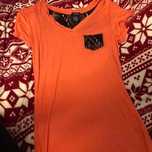 Peach and multi colored t shirt.